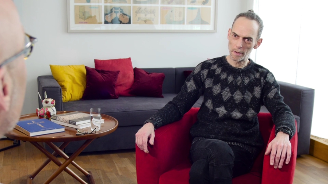 Arik Hayut im Rotel Sessel in einem Wohnzimmer beim Interview